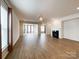 Open living room features wood flooring, a fireplace, and plenty of natural light at 2023 Moultrie Ct, Fort Mill, SC 29707