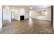 Spacious living room with fireplace, wood floors, and seamless flow to other rooms at 2023 Moultrie Ct, Fort Mill, SC 29707