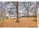 Large fenced backyard with trees, a portable basketball court and exterior storage shed at 2232 Mancke Dr, Rock Hill, SC 29732