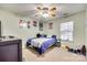 This cozy bedroom has a carpeted floor, ceiling fan, and a window letting in natural light at 2232 Mancke Dr, Rock Hill, SC 29732