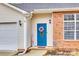 Close-up of the entryway, featuring a blue front door with a decorative wreath and a 'Welcome' sign at 2232 Mancke Dr, Rock Hill, SC 29732