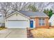 Charming single-Gathering home showcasing a brick and vinyl facade, attached garage, and a welcoming blue front door at 2232 Mancke Dr, Rock Hill, SC 29732