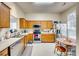 Functional kitchen features wooden cabinetry, stainless steel appliances, and a cozy dining area at 2232 Mancke Dr, Rock Hill, SC 29732