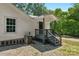 Back entrance of this home with gray stairs, white siding, and covered entry at 233 Proctor St, Gastonia, NC 28052