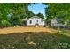 A full backyard view featuring an open grassy area, bordered with a partial fence at 233 Proctor St, Gastonia, NC 28052