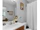 Well-lit bathroom with modern sink and faucet, decorative clock, and neutral color scheme at 233 Proctor St, Gastonia, NC 28052