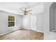Neutral bedroom showcasing tile flooring, a ceiling fan, and a bright window at 233 Proctor St, Gastonia, NC 28052
