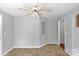 Neutral bedroom showcasing tile flooring, a ceiling fan, and a bright window, with an arched niche at 233 Proctor St, Gastonia, NC 28052
