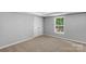 Cozy bedroom featuring plush carpeting, a double door closet, and a sunlit window at 233 Proctor St, Gastonia, NC 28052
