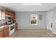 Well-lit kitchen area featuring wood cabinets and easy view of the window to the outside at 233 Proctor St, Gastonia, NC 28052