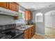 Kitchen view with wood cabinets, laminate countertops, stainless steel sink, and black appliances at 233 Proctor St, Gastonia, NC 28052