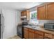 Bright kitchen featuring wood cabinets, laminate countertops, and modern black appliances at 233 Proctor St, Gastonia, NC 28052