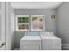 Dedicated laundry room with side-by-side washer and dryer units at 233 Proctor St, Gastonia, NC 28052