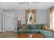 Cozy living room featuring a teal couch, natural light, and modern decor at 233 Proctor St, Gastonia, NC 28052