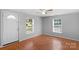 Inviting living room with a light color paint and herringbone floors. Windows provide natural light at 233 Proctor St, Gastonia, NC 28052