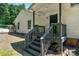 Rear entrance to home featuring gray painted steps with handrail and a painted door at 233 Proctor St, Gastonia, NC 28052