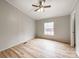 Bedroom featuring wood-look flooring, a ceiling fan, and a window with a view at 236 Sailwinds Rd, Mooresville, NC 28115