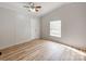 Bright bedroom features a ceiling fan, neutral walls, and beautiful flooring at 236 Sailwinds Rd, Mooresville, NC 28115