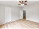 This bedroom features wood-look flooring, a ceiling fan, and multiple doorways at 236 Sailwinds Rd, Mooresville, NC 28115