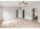 This room features wood-look flooring, a ceiling fan with lights, and multiple doorways at 236 Sailwinds Rd, Mooresville, NC 28115