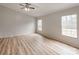 Bedroom featuring three windows, wood-look flooring, and a ceiling fan with lighting at 236 Sailwinds Rd, Mooresville, NC 28115