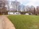 Expansive yard showcasing the home's exterior with additional buildings at 236 Sailwinds Rd, Mooresville, NC 28115