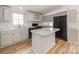 This kitchen features gray cabinets, a speckled countertop, an island, and black appliances at 236 Sailwinds Rd, Mooresville, NC 28115