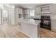 Well-lit kitchen with a large island and stainless steel appliances at 236 Sailwinds Rd, Mooresville, NC 28115