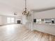 Open living space with decorative light fixture and countertop kitchen access at 236 Sailwinds Rd, Mooresville, NC 28115