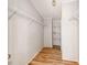 Walk-in closet with white wire shelving and wood-look flooring at 236 Sailwinds Rd, Mooresville, NC 28115