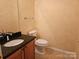 Half bathroom featuring a granite countertop and sink with a matching toilet at 2656 Polo Club Blvd, Matthews, NC 28105