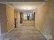Spacious living area with tiled flooring, connecting seamlessly to the kitchen, perfect for open-concept living at 2656 Polo Club Blvd, Matthews, NC 28105