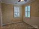 Charming room featuring two windows with shutters, neutral colors, and tile floors at 2656 Polo Club Blvd, Matthews, NC 28105