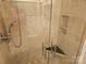 Modern tiled shower with a glass door, dual shower heads, and convenient built-in shelving at 2656 Polo Club Blvd, Matthews, NC 28105