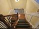 Carpeted staircase with wood railings and decorative iron balusters at 2656 Polo Club Blvd, Matthews, NC 28105