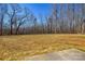 Large wooded backyard with mature trees provides privacy and a natural setting at 268 Lytton Farm Rd, Troutman, NC 28166