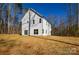 Back exterior view of a white two-story home with a large grassy backyard at 268 Lytton Farm Rd, Troutman, NC 28166