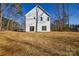 Exterior rear view of a white two-story home with a spacious backyard at 268 Lytton Farm Rd, Troutman, NC 28166