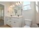 Bright bathroom featuring a double vanity, quartz countertop, and modern lighting fixtures at 268 Lytton Farm Rd, Troutman, NC 28166