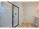 Modern bathroom featuring a glass-enclosed shower and wood-look flooring at 268 Lytton Farm Rd, Troutman, NC 28166