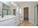Stylish bathroom with a double vanity, quartz countertop, and wood-look flooring at 268 Lytton Farm Rd, Troutman, NC 28166
