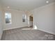 Bright bedroom with neutral tones, plush carpet, and natural light from two windows at 268 Lytton Farm Rd, Troutman, NC 28166