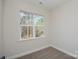 Empty carpeted bedroom with a window showing outdoor view and natural light at 268 Lytton Farm Rd, Troutman, NC 28166