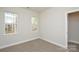 A bright, carpeted bedroom with two windows at 268 Lytton Farm Rd, Troutman, NC 28166