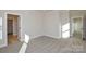 Spacious bedroom with neutral carpet, featuring a view of additional rooms via open doorways at 268 Lytton Farm Rd, Troutman, NC 28166