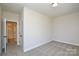 Well-lit bedroom with carpet, light walls and white trim; entry to the bathroom in view at 268 Lytton Farm Rd, Troutman, NC 28166