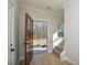 Warm foyer with open door, light wood floors, and staircase leading to the second floor at 268 Lytton Farm Rd, Troutman, NC 28166