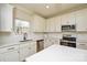 Modern kitchen with stainless steel appliances, white cabinetry, and quartz countertops at 268 Lytton Farm Rd, Troutman, NC 28166