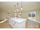Open-concept living room with a large center island, recessed lighting, and sliding door access to the backyard at 268 Lytton Farm Rd, Troutman, NC 28166