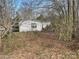Single-story home with white siding set against a backdrop of trees at 282 Dixon Rd, Lancaster, SC 29720
